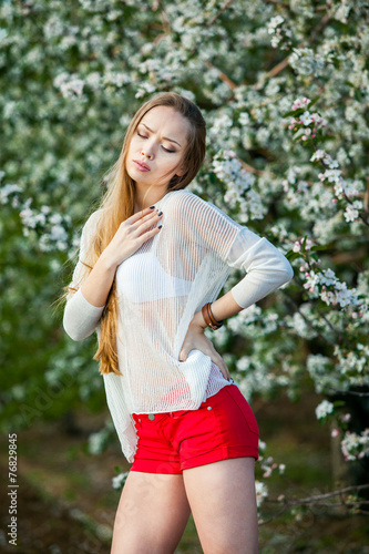 Spring portrait of a woman in a flowered garden