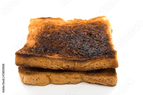 Burnt toast slice isolated on white background