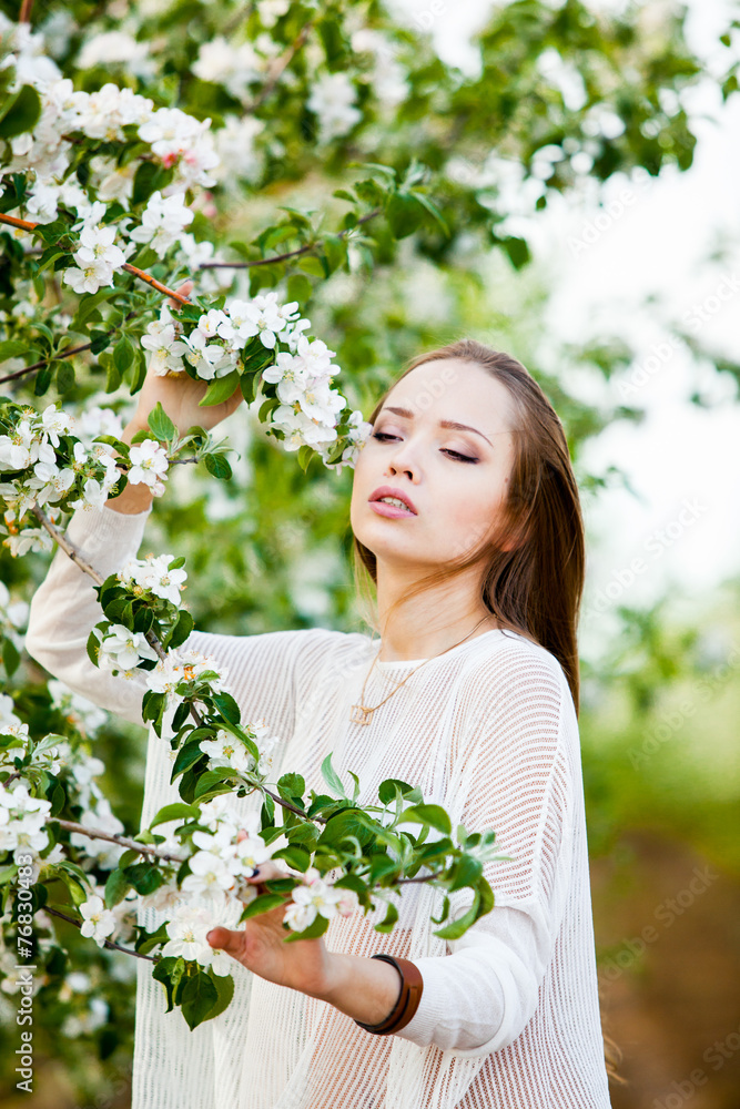 Spring portrait of a woman in a flowered garden Spring portrait of a woman in a flowered garden