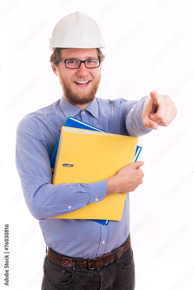 Young happy engineer in helmet pointing with finger Young happy engineer in helmet pointing with finger