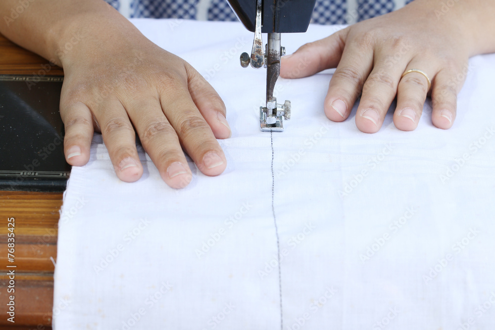 woman working with sewing machine.