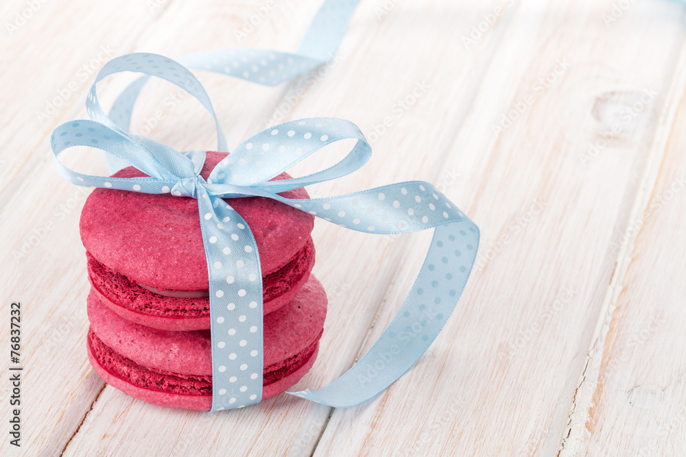 Red macarons with blue ribbon Red macarons with blue ribbon
