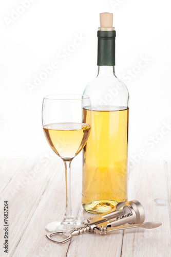 White wine glass, bottle and corkscrew