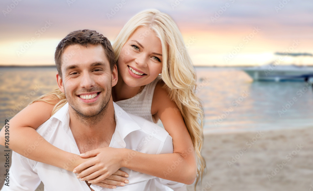 happy couple having fun over beach background happy couple having fun over beach background