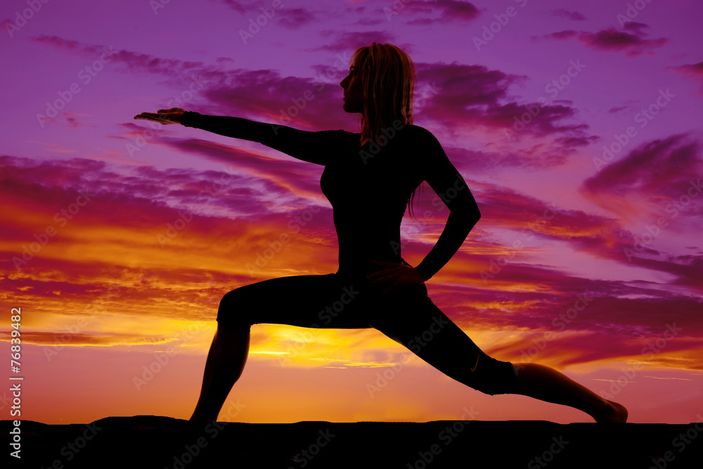 silhouette of woman lunge arm out