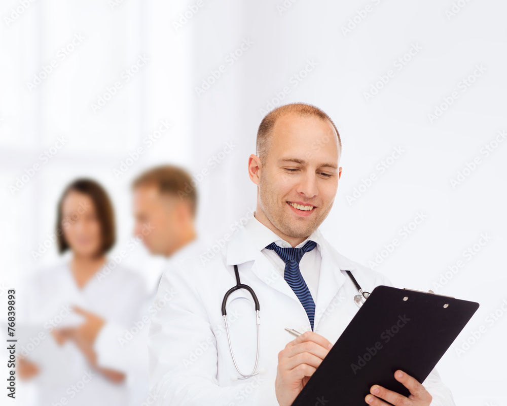 smiling male doctor with clipboard and stethoscope smiling male doctor with clipboard and stethoscope