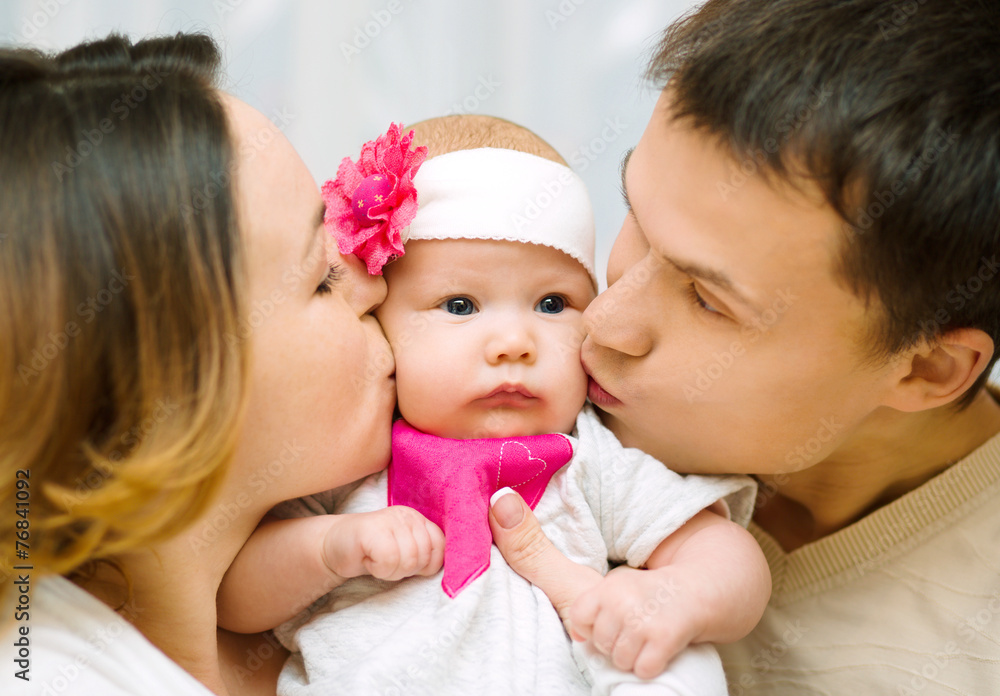 Parents kiss baby Parents kiss baby