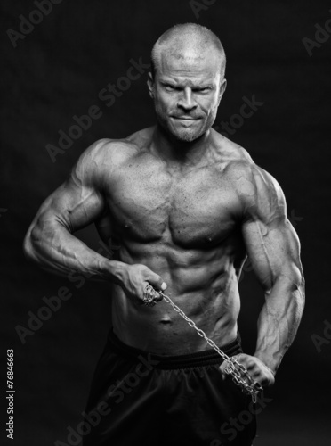 Muscular bodybuilder man with a chain