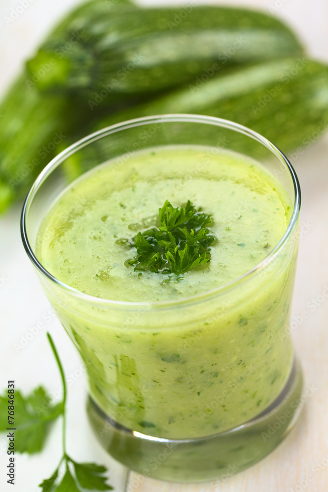 Zucchini cream soup garnished with curled parsley Zucchini cream soup garnished with curled parsley