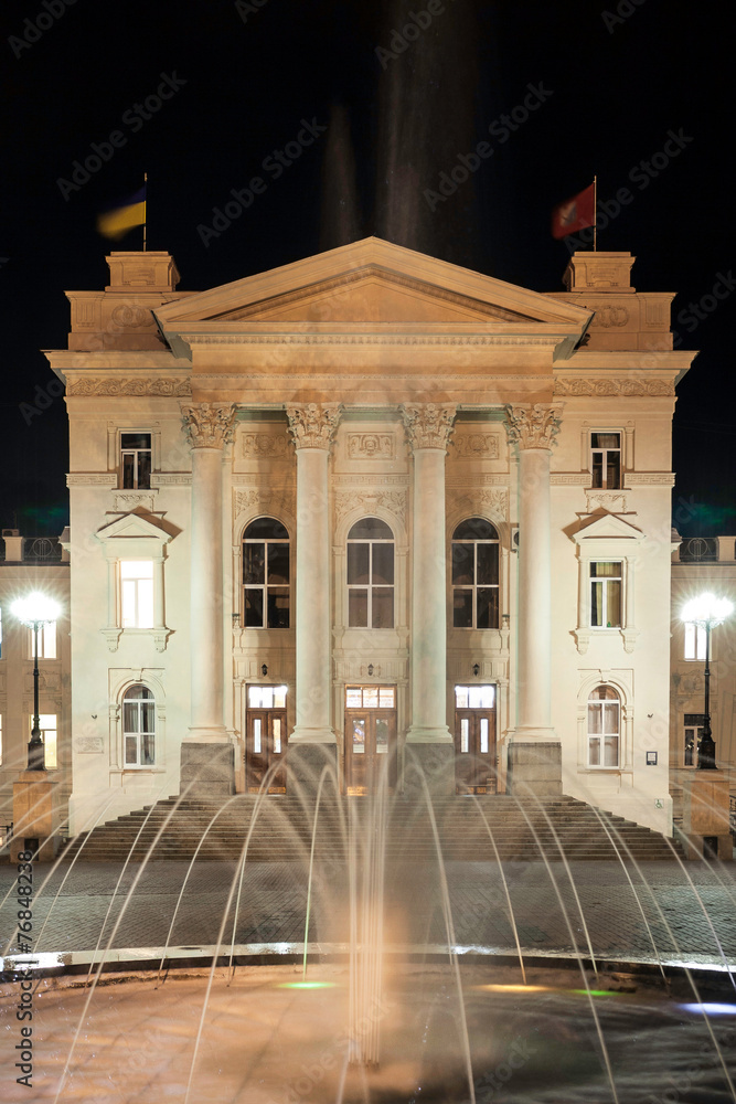 Fountain on the background of the historic buildings at night
