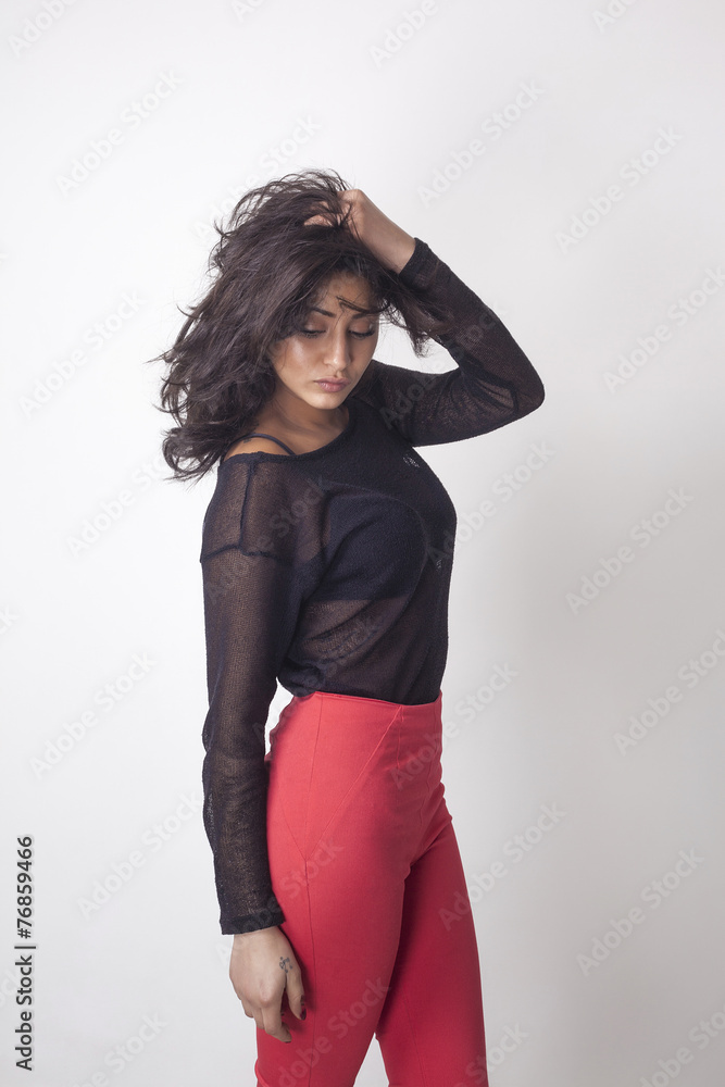 Beautiful woman posing and touching hair Beautiful woman posing and touching hair