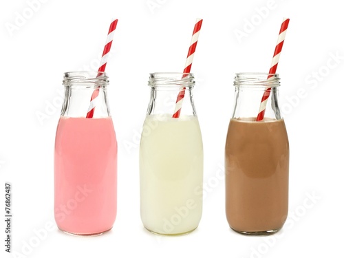 Fotografie Strawberry regular and chocolate milk in bottles isolated
