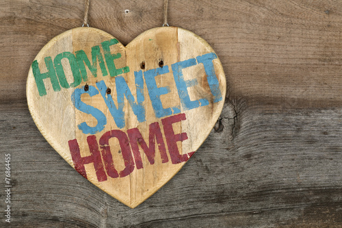 'Home Sweet Home' message wooden heart sign on rough grey wooden