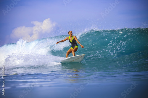 Surfer girl on Amazing Blue Wave