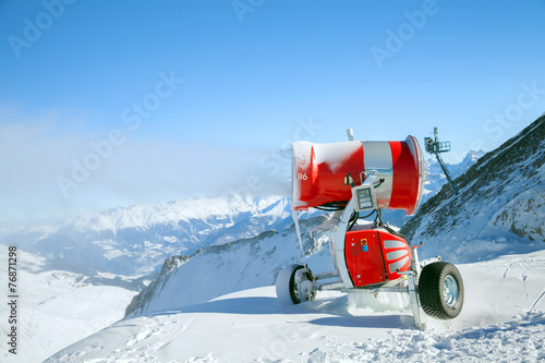 Red modern snow canon is making snow in European Alps © anrymos