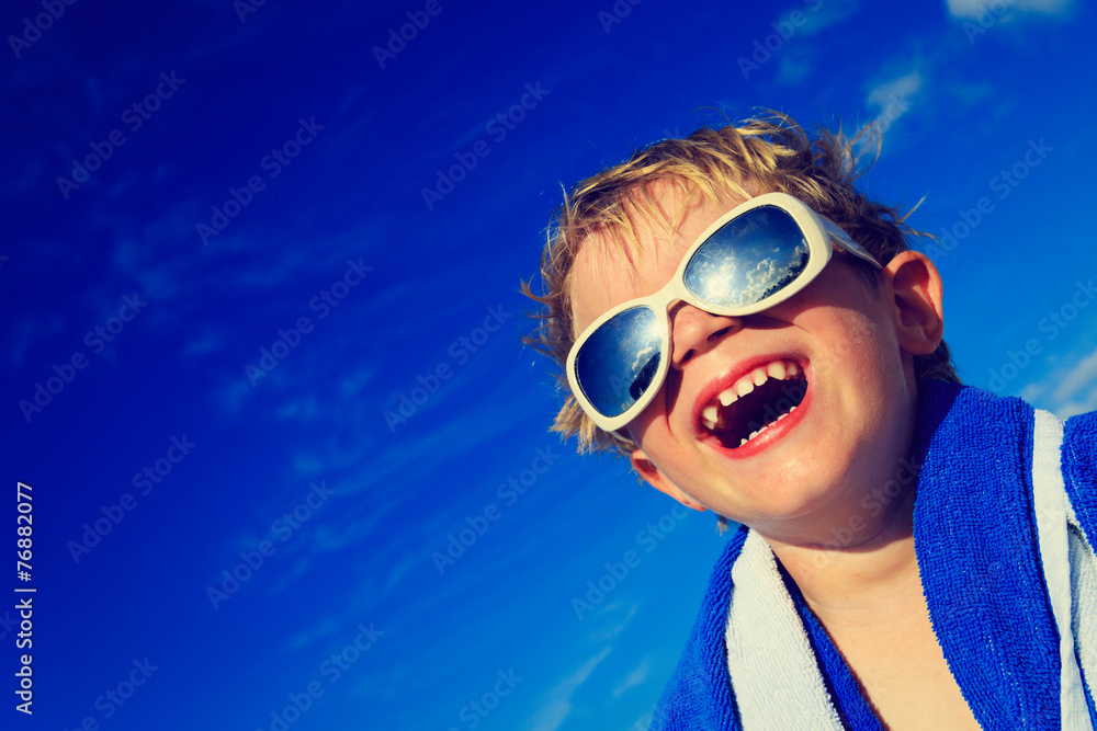 little boy laugh wrapped in beach towel on sky little boy laugh wrapped in beach towel on sky