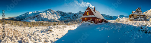 Big panorama of mountain small cottage in a winter dawn