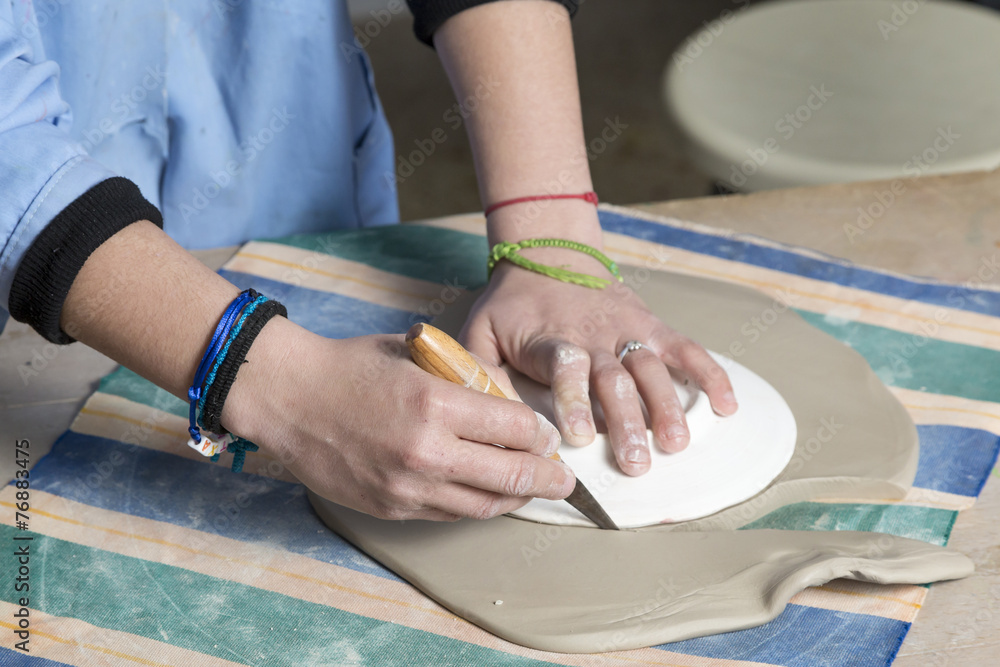 cutting the clay to shape