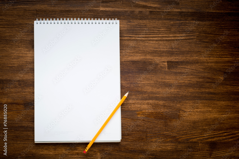 notebook with pencile on a wooden