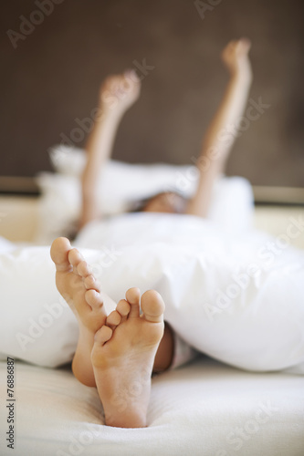 Morning stretching in comfortable bed
