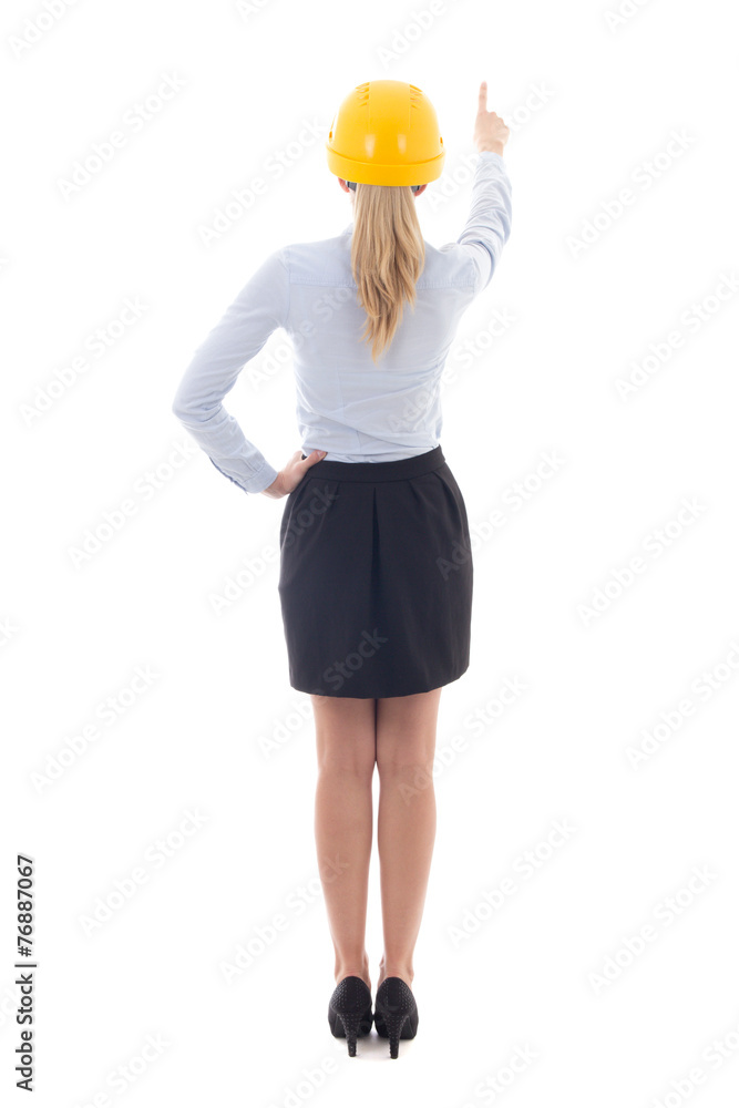 back view of business woman in builder helmet pointing at someth back view of business woman in builder helmet pointing at someth