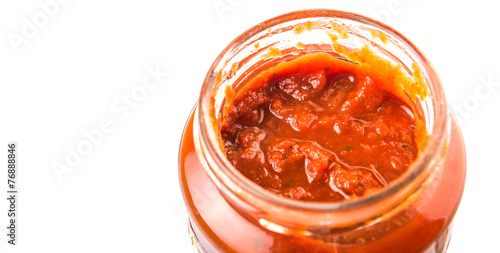 Spaghetti sauce in a jar over white background