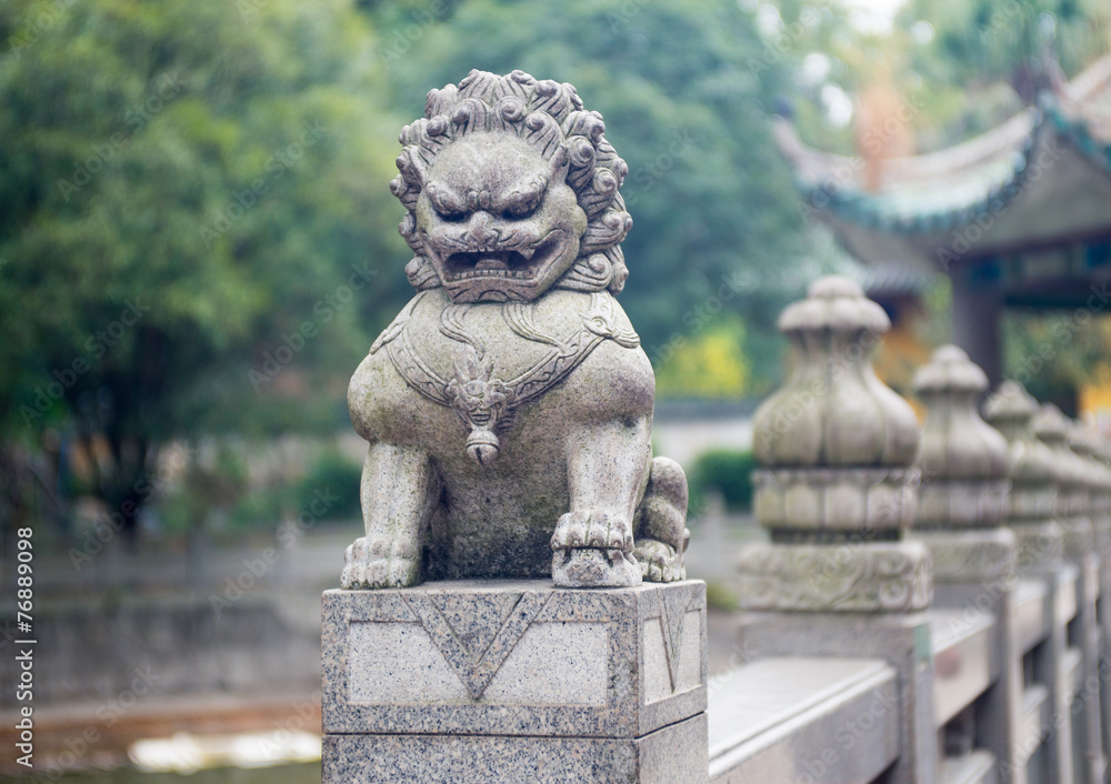 stone lion sculpture on the fence in the park stone lion sculpture on the fence in the park