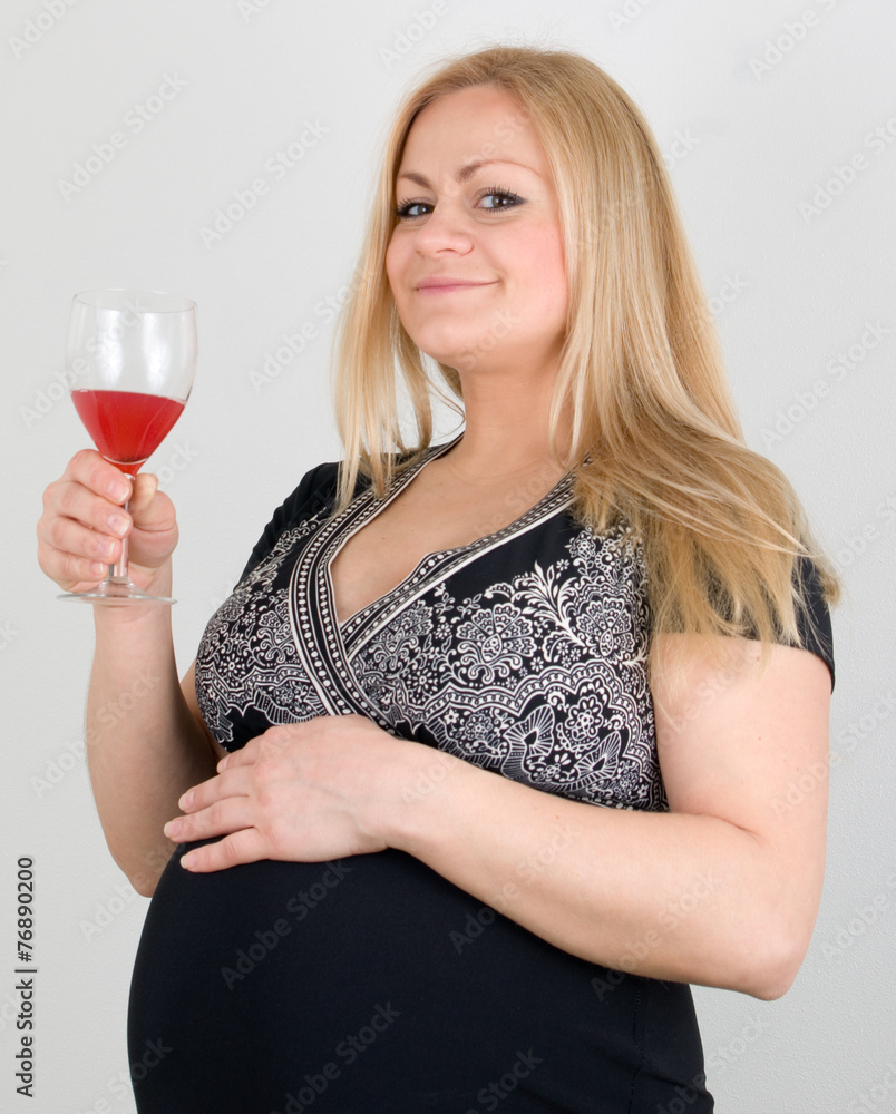 Happy pregnant russian blonde woman in a black dress Happy pregnant russian blonde woman in a black dress