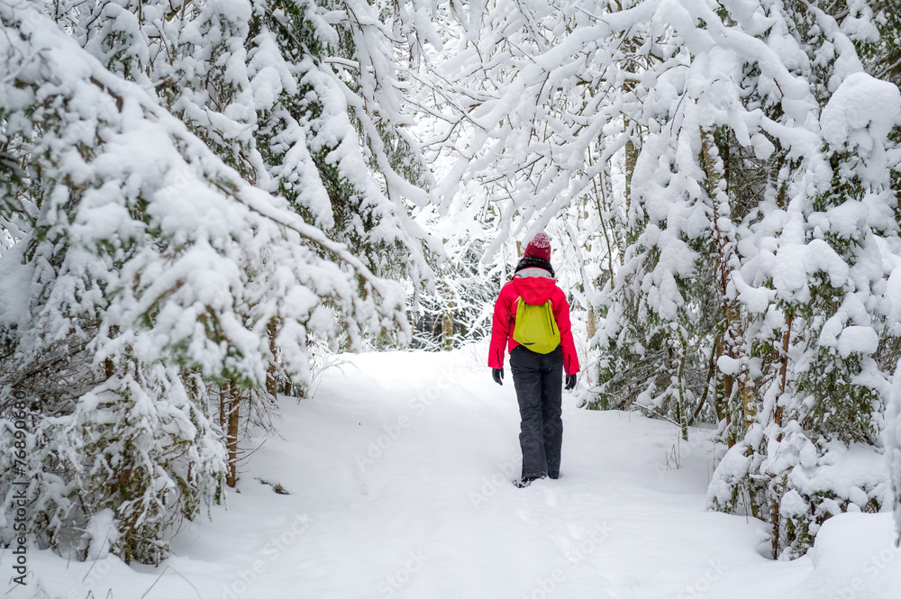 Woman in snowy forest