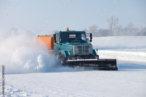 Snowplow is cleaning a road