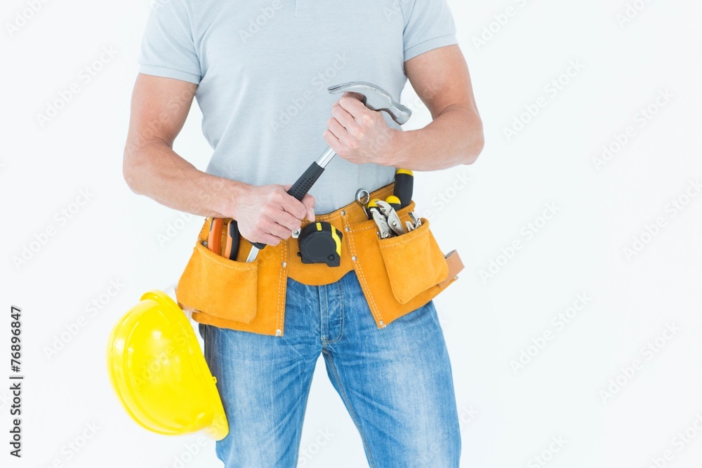 Worker holding hammer over white background Worker holding hammer over white background