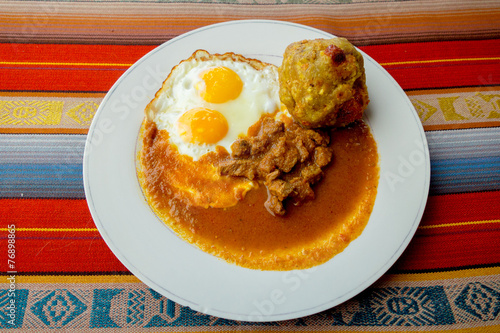 Bolon de verde with fried egg and meat stew ecuadorian food