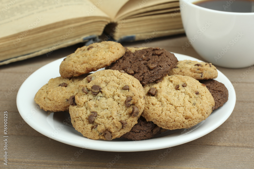 chocolate chip cookies on a plate and coffee with a book chocolate chip cookies on a plate and coffee with a book