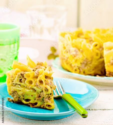 macaroni baked pudding with meat on a plate.