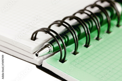 Open notebook with green pen