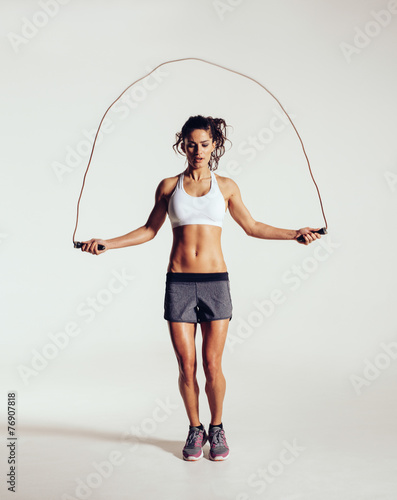 Fit young woman skipping rope