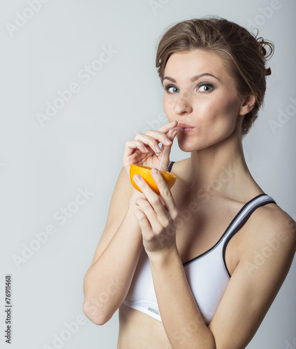 beautiful athletic girl energetic happy drinking orange juice