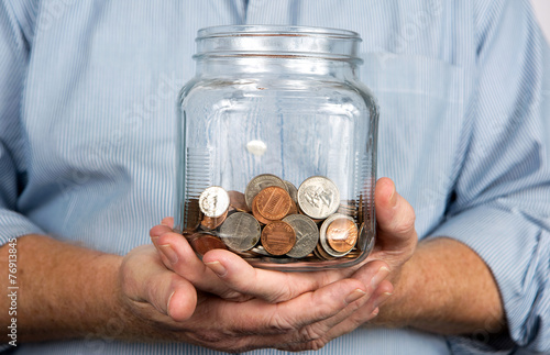 Holding A Jar Of Coins Money