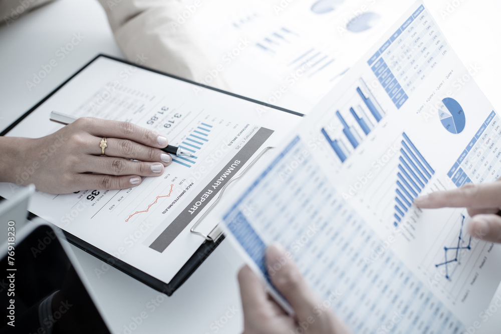 Business people discussing the charts and graphs showing the res Business people discussing the charts and graphs showing the res