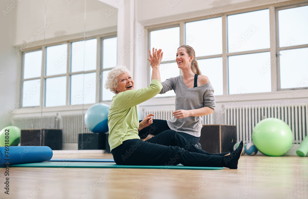 Senior woman rejoicing health success with her instructor Senior woman rejoicing health success with her instructor