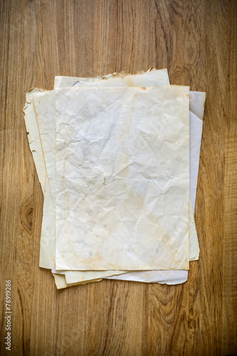 Stack of old papers on wooden background