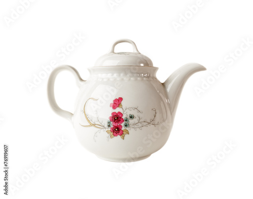 Porcelain teapot with floral patterns over  white