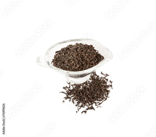 Black tea in a glass bowl isolated over white
