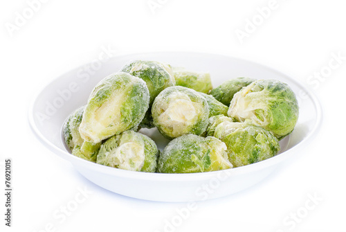 Frozen brussels sprouts on white background