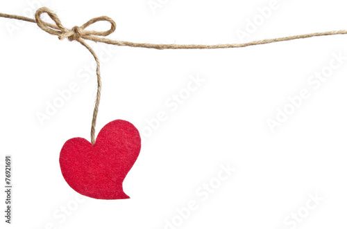 Red fabric heart hanging on the clothesline