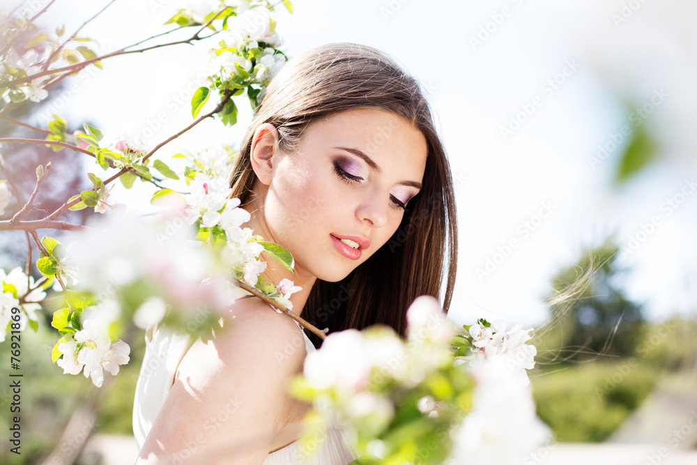 Beautiful girl in a cherry blossom garden Beautiful girl in a cherry blossom garden