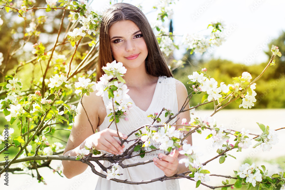 Beautiful girl in a cherry blossom garden Beautiful girl in a cherry blossom garden