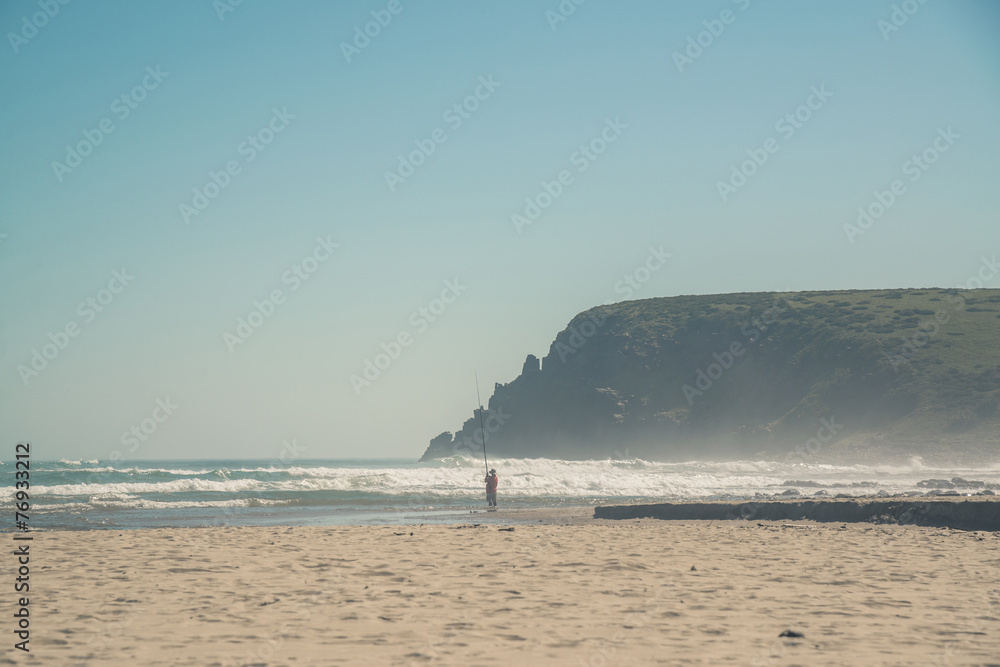 Man fishing at the beach of Morgans Bay. Eastern Cape. South Afr