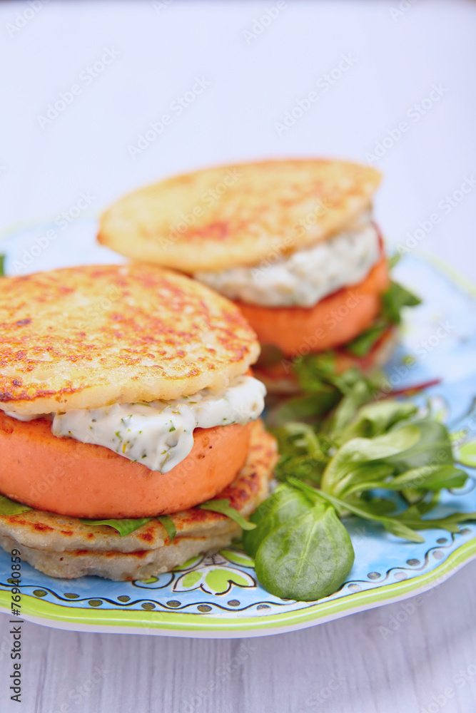 Salmon burger with potato pancakes
