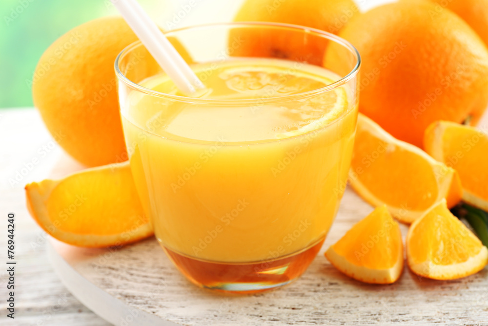 Glass of orange juice with straw and slices Glass of orange juice with straw and slices